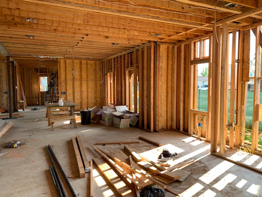 new home under construction with exposed framing and open walls - how to plan your ac system during the building process